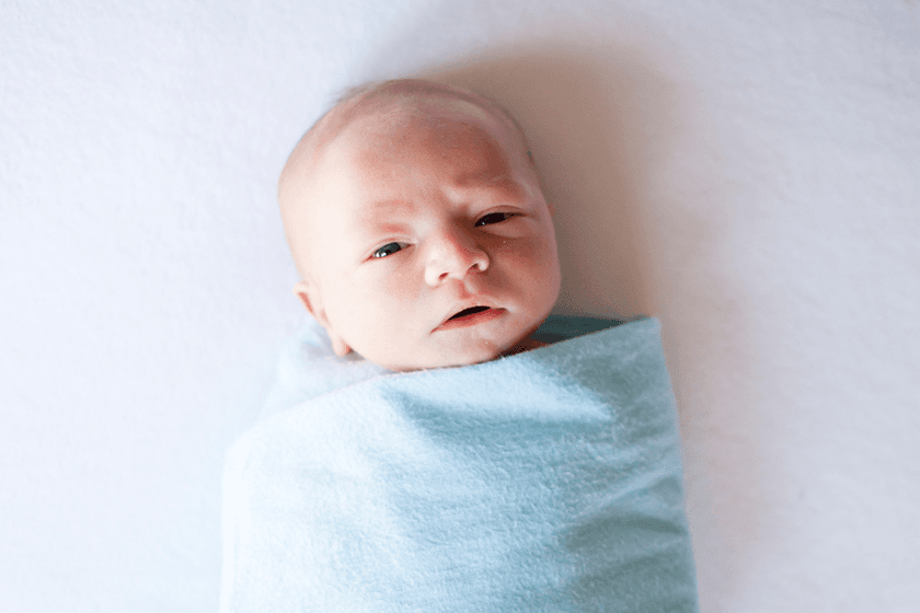 Properly swaddled newborn baby sleeping peacefully
